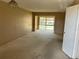 Spacious living room featuring neutral walls and carpet with a window and natural light at 1845 S Highland Ave # 6-11, Largo, FL 33756