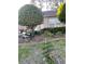 Landscaped front yard featuring a variety of greenery and a decorative bench at 18607 Bent Pine Dr, Hudson, FL 34667