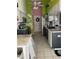 Well-equipped kitchen with a central island, white cabinets, stainless steel appliances, and tiled floor at 18607 Bent Pine Dr, Hudson, FL 34667