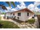 Backyard view of the house featuring a stone path, grill, and a screened-in pool area at 1874 Cameo Way, Clearwater, FL 33756
