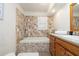Elegant bathroom showcasing a soaking tub with decorative tile surround, a vanity with storage, and modern finishes at 1874 Cameo Way, Clearwater, FL 33756