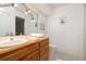 Bathroom featuring a wood vanity, with soft towels, white tile floor, a toilet, and a cute 'Bath Co.' print at 1874 Cameo Way, Clearwater, FL 33756