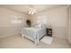 A bright bedroom featuring neutral walls, white shutters on the windows, and a cozy queen-size bed at 1874 Cameo Way, Clearwater, FL 33756