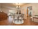 Charming dining area with hardwood floors and an adjacent living space bathed in natural light at 1874 Cameo Way, Clearwater, FL 33756