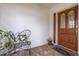 Inviting front entry with brick flooring, butterfly bench and decorative front door at 1874 Cameo Way, Clearwater, FL 33756