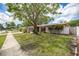 Charming home with mature landscaping and well-manicured lawn at 1874 Cameo Way, Clearwater, FL 33756