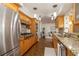 Well-equipped kitchen featuring stainless steel appliances, granite countertops and wooden cabinetry at 1874 Cameo Way, Clearwater, FL 33756