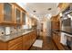 Spacious kitchen with wooden cabinetry, granite counters, and stainless steel appliances, offering plenty of workspace at 1874 Cameo Way, Clearwater, FL 33756
