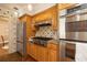 Well-equipped kitchen featuring stainless steel appliances, granite countertops and wooden cabinetry at 1874 Cameo Way, Clearwater, FL 33756