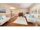 Bright living room featuring hardwood flooring, plantation shutters, and stylish furnishings at 1874 Cameo Way, Clearwater, FL 33756