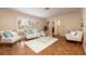 Bright living room featuring hardwood flooring, plantation shutters, and stylish furnishings at 1874 Cameo Way, Clearwater, FL 33756