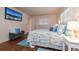 Relaxing main bedroom boasting neutral tones, shuttered windows, and a mounted TV at 1874 Cameo Way, Clearwater, FL 33756