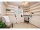 A bright office featuring neutral walls, shelves, a desk area, a chair and a ceiling fan at 1874 Cameo Way, Clearwater, FL 33756