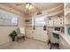 Office featuring built-in shelving and cabinets, a desk, and a large window for natural light at 1874 Cameo Way, Clearwater, FL 33756