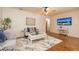 Inviting sitting room with stylish decor, a sleek coffee table, and a mounted television at 1874 Cameo Way, Clearwater, FL 33756