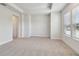 Bright, carpeted bedroom with trey ceilings, neutral paint, and large window at 2121 1St N Ave, St Petersburg, FL 33713
