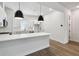 Contemporary kitchen featuring an island, stainless steel appliances, white cabinets, and modern finishes at 2121 1St N Ave, St Petersburg, FL 33713