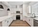 Modern kitchen with sleek appliances, white cabinets, an island, and stylish pendant lighting at 2121 1St N Ave, St Petersburg, FL 33713
