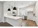 Bright kitchen with an island, white cabinets, stainless steel appliances, and modern lighting at 2121 1St N Ave, St Petersburg, FL 33713