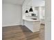Modern kitchen featuring an island with pendant lights, white cabinets, and stainless steel appliances at 2121 1St N Ave, St Petersburg, FL 33713
