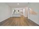 Bright living room featuring open floor plan to kitchen with wood floors and white walls at 2121 1St N Ave, St Petersburg, FL 33713