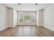 Open living room with three large windows that bring in natural light and wood floors at 2121 1St N Ave, St Petersburg, FL 33713