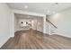 Bright living room open to kitchen featuring wood floors, stairs, and neutral paint at 2121 1St N Ave, St Petersburg, FL 33713