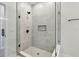 Modern tiled shower with black hardware, frameless glass enclosure, and built-in niche at 2121 1St N Ave, St Petersburg, FL 33713