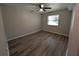 Bedroom with wood flooring and ceiling fan, offering a simple yet comfortable space at 2306 Hammock Pine Blvd # 2306, Clearwater, FL 33761
