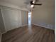 Bedroom featuring ample closet space, wood flooring, and a ceiling fan at 2306 Hammock Pine Blvd # 2306, Clearwater, FL 33761