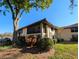 Well-maintained two-story condo with screened balcony and mature landscaping under a clear blue sky at 2306 Hammock Pine Blvd # 2306, Clearwater, FL 33761