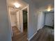 Hallway with wood-look flooring leading to a bathroom and other rooms at 2306 Hammock Pine Blvd # 2306, Clearwater, FL 33761