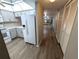Bright kitchen featuring gray cabinets, modern white appliances, and wood-look flooring at 2306 Hammock Pine Blvd # 2306, Clearwater, FL 33761