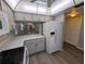 Stylish kitchen with white appliances, gray cabinets, quartz countertops, and open view to the living space at 2306 Hammock Pine Blvd # 2306, Clearwater, FL 33761