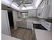 Bright kitchen featuring light gray cabinets, white appliances, and modern finishes at 2306 Hammock Pine Blvd # 2306, Clearwater, FL 33761