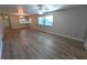 Bright living room featuring large windows, modern flooring, and a view into the kitchen at 2306 Hammock Pine Blvd # 2306, Clearwater, FL 33761