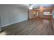 Spacious living room with ceiling fan, modern flooring, and access to the kitchen area at 2306 Hammock Pine Blvd # 2306, Clearwater, FL 33761