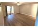 This bright living room features new wood flooring, a ceiling fan, and a patio at 2306 Hammock Pine Blvd # 2306, Clearwater, FL 33761