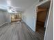 Open living area features mirrored wall and sliding doors to a screened-in patio for extra space at 2306 Hammock Pine Blvd # 2306, Clearwater, FL 33761