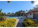 Community pool and hot tub area surrounded by mature landscaping and palm trees offers a relaxing oasis at 2306 Hammock Pine Blvd # 2306, Clearwater, FL 33761