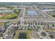 Expansive aerial view of a residential neighborhood with sports complex and multiple lakes at 2404 Dovesong Trace Dr, Ruskin, FL 33570