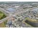 Aerial view showcases a vibrant community with lakes, manicured landscaping, and interconnected streets at 2404 Dovesong Trace Dr, Ruskin, FL 33570