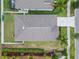 Aerial view of the property showcases the roof, spacious yard, and surrounding landscaping at 2404 Dovesong Trace Dr, Ruskin, FL 33570