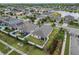 An aerial view of a single-Gathering home, featuring a screened-in patio, manicured lawns, and neighborhood views at 2404 Dovesong Trace Dr, Ruskin, FL 33570
