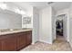 Bathroom featuring granite countertops, double vanity, and walk-in closet at 2404 Dovesong Trace Dr, Ruskin, FL 33570