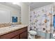 Clean bathroom with a granite countertop vanity, tile flooring, and a decorative shower curtain for a serene feel at 2404 Dovesong Trace Dr, Ruskin, FL 33570