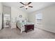 Inviting bedroom with large window, ceiling fan, and carpeted floor at 2404 Dovesong Trace Dr, Ruskin, FL 33570