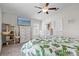 Well-lit bedroom with ceiling fan, TV, dresser, and cat tree at 2404 Dovesong Trace Dr, Ruskin, FL 33570