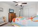 Comfortable bedroom featuring a ceiling fan, TV, carpet, and wooden dresser at 2404 Dovesong Trace Dr, Ruskin, FL 33570