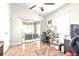 Functional home office space with sliding glass doors to the patio, tile flooring, and a ceiling fan at 2404 Dovesong Trace Dr, Ruskin, FL 33570